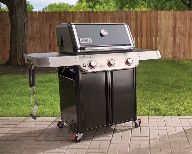 Weber gas grill on a backyard patio